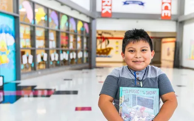 Student Posing With A Book