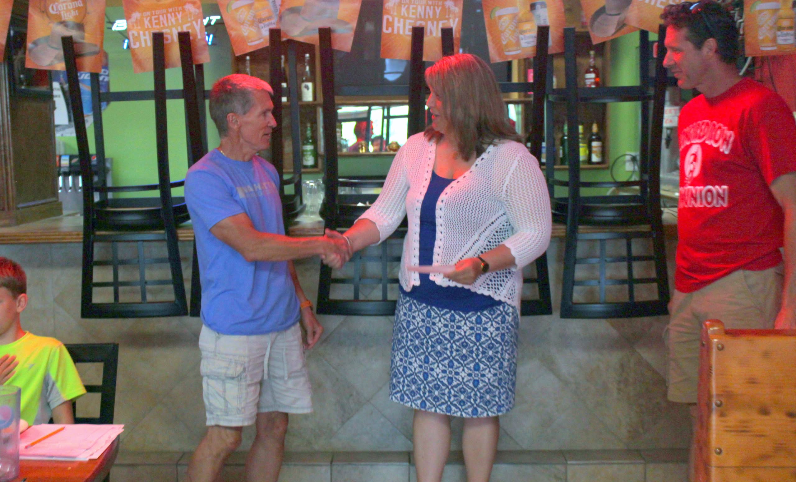 Foundation Board member Lori Smith accepts check from CRC