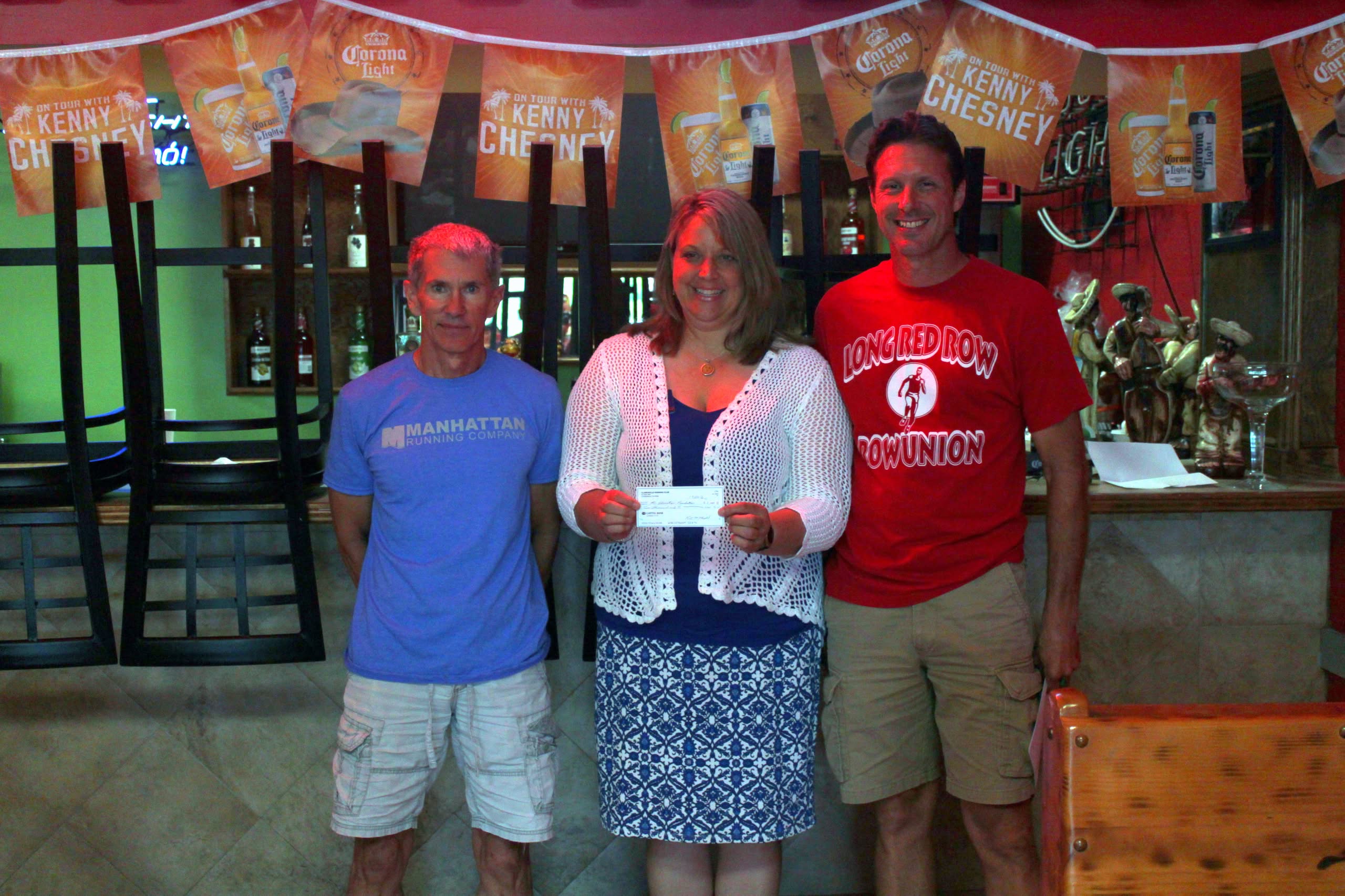 Foundation Board member Lori Smith accepts check from CRC